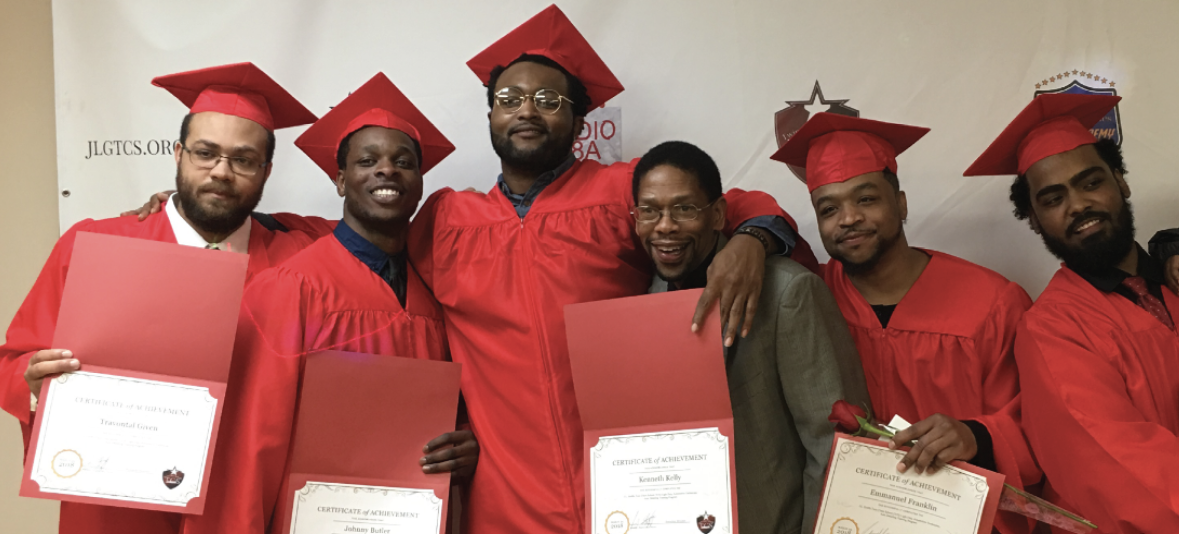 Six graduates posing with their diplomas.
